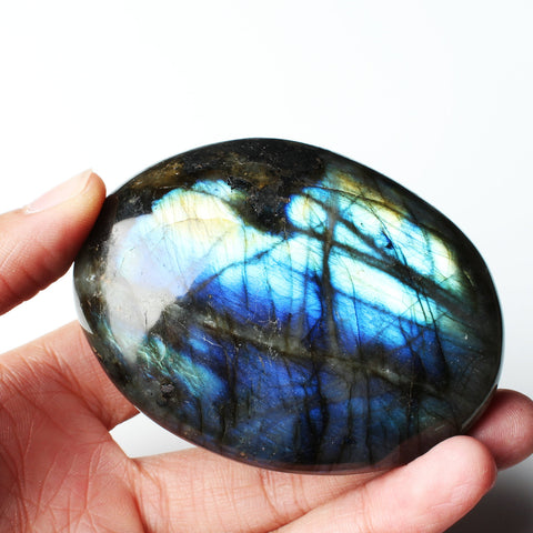 Stone Pieces Handle a Piece of Raw Moonstone Ore Specimen in a Fish Tank