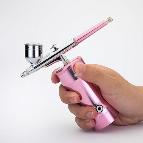 Manicure. Beauty. Cake coloring. Hand-held air pump charging portable airbrush