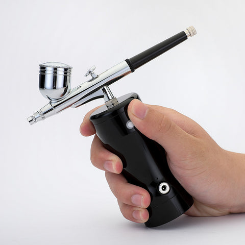Manicure. Beauty. Cake coloring. Hand-held air pump charging portable airbrush